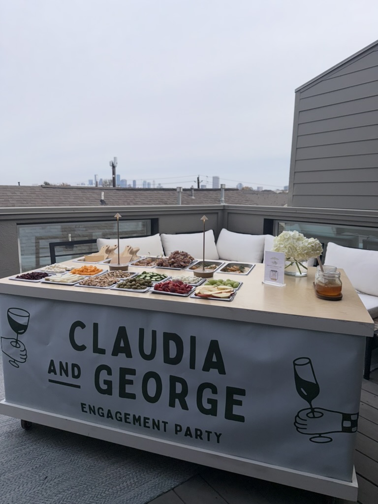 Custom-branded charcuterie cart at an engagement party