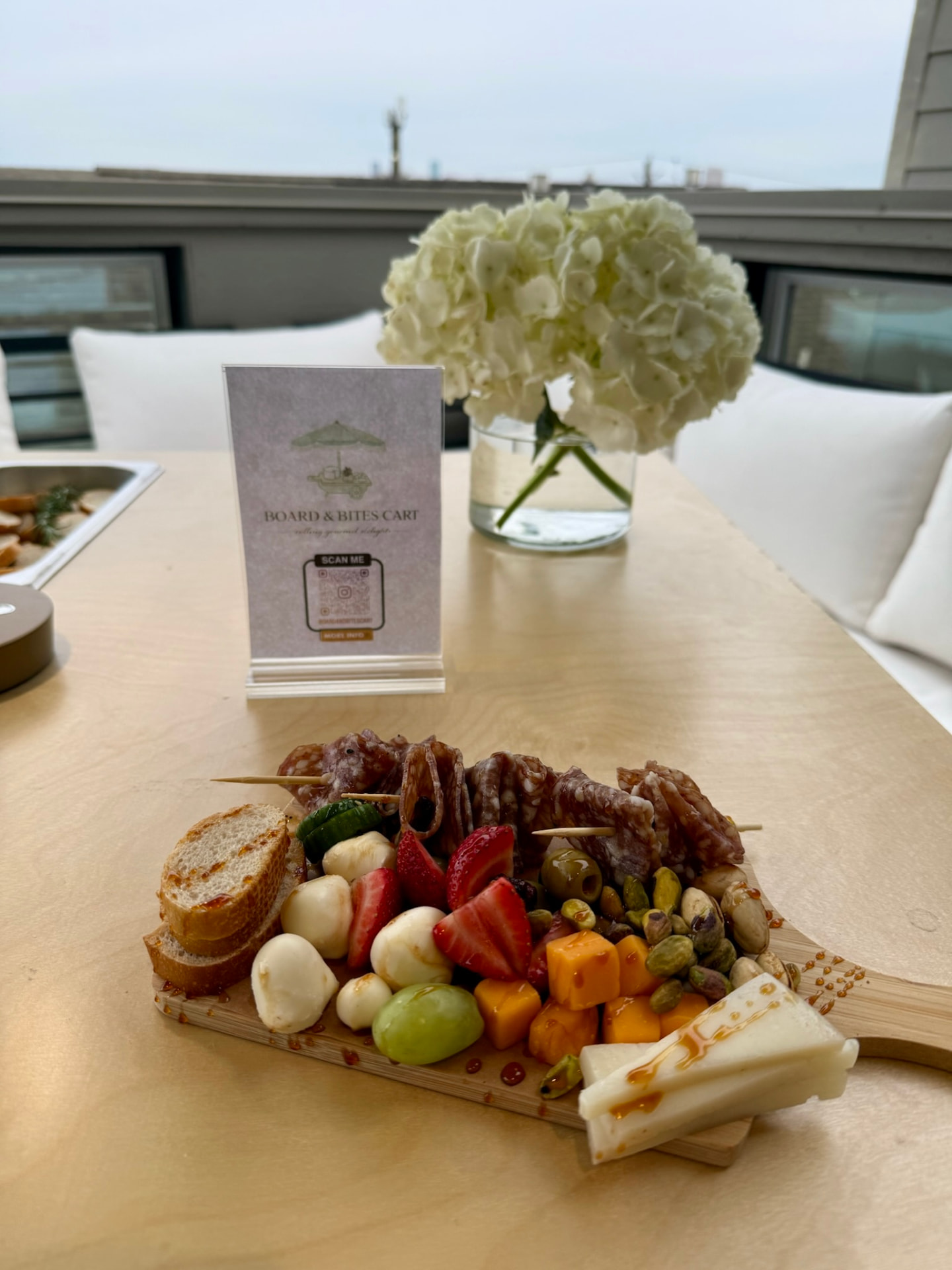 Individual charcuterie board with salami, cheese, berries and pistachios